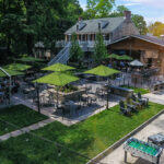 an aerial view of a restaurant with green umbrellas.