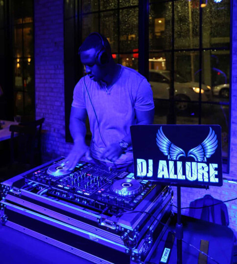 a dj in headphones and headphones standing in front of a dj's.