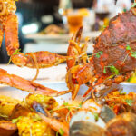 a plate of food with lobsters and mussels.