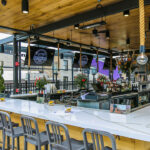 a bar with lots of chairs around it.