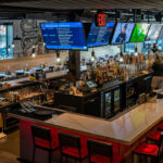 a bar with a lot of people sitting at it.