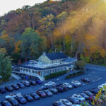 an aerial view of a parking lot with a mountain in the background.