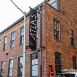 A brick building with a sign that says atlas.